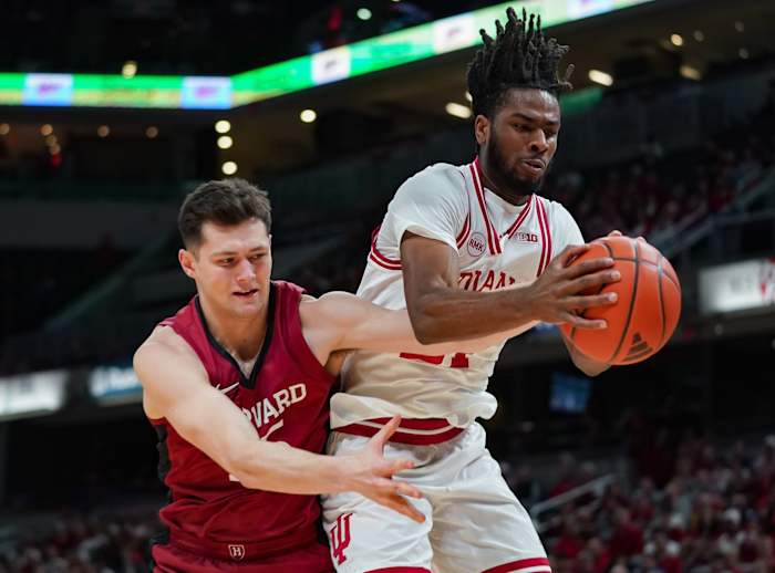Indiana Hoosiers forward Mackenzie Mgbako (21) and Harvard Crimson forward Luca Ace-Nasteski (35) battle for a rebound during the game against Harvard in Gainbridge Fieldhouse.